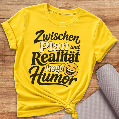 Zwischen Plan Und Realität Liegt Humor T-Shirt